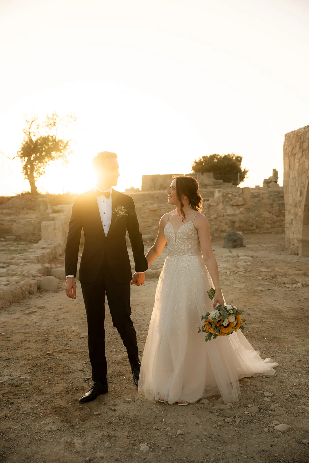 Couple walking at ruins during sunset