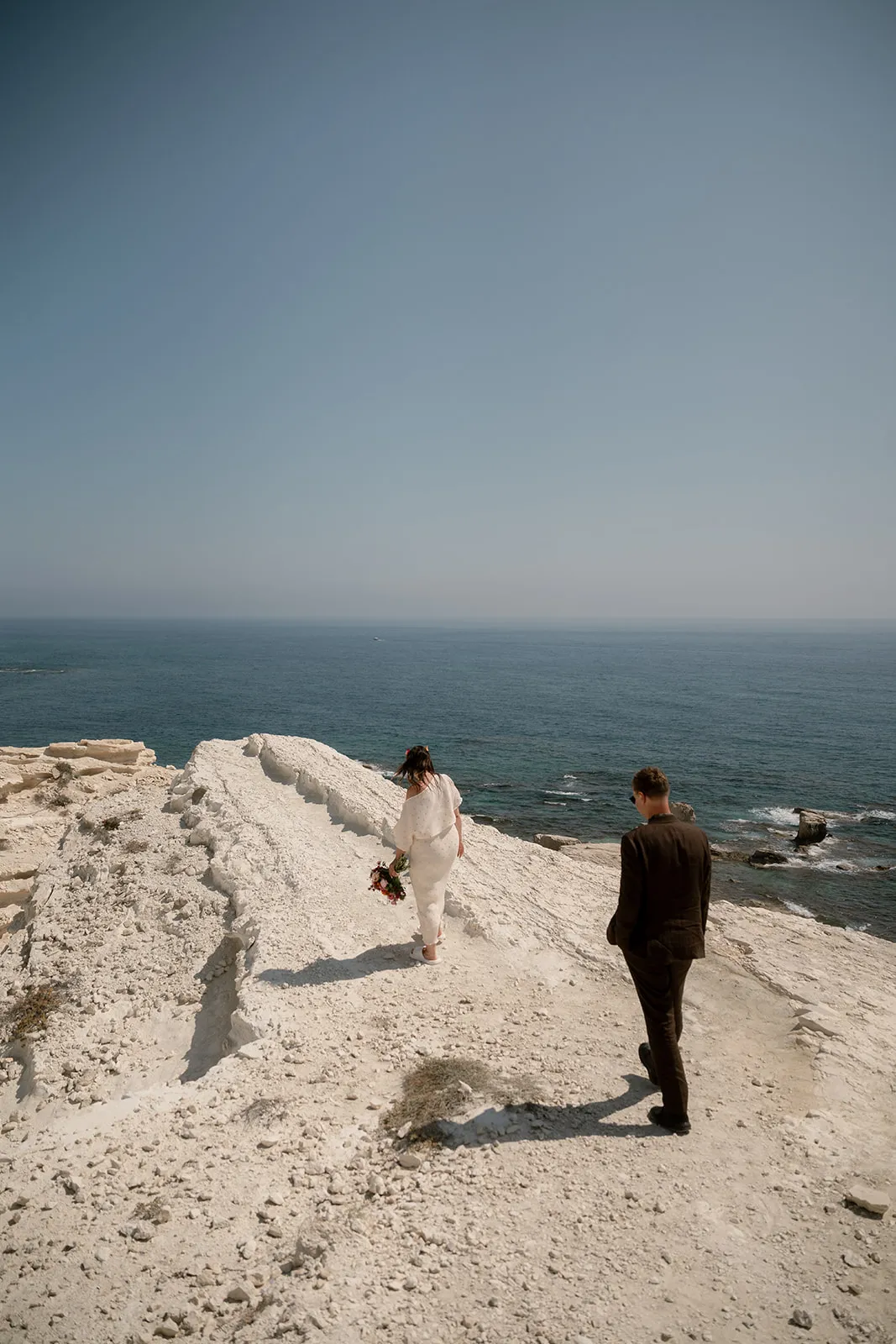 Couple on white cliffs with ocean view — cinematic wedding film Cyprus