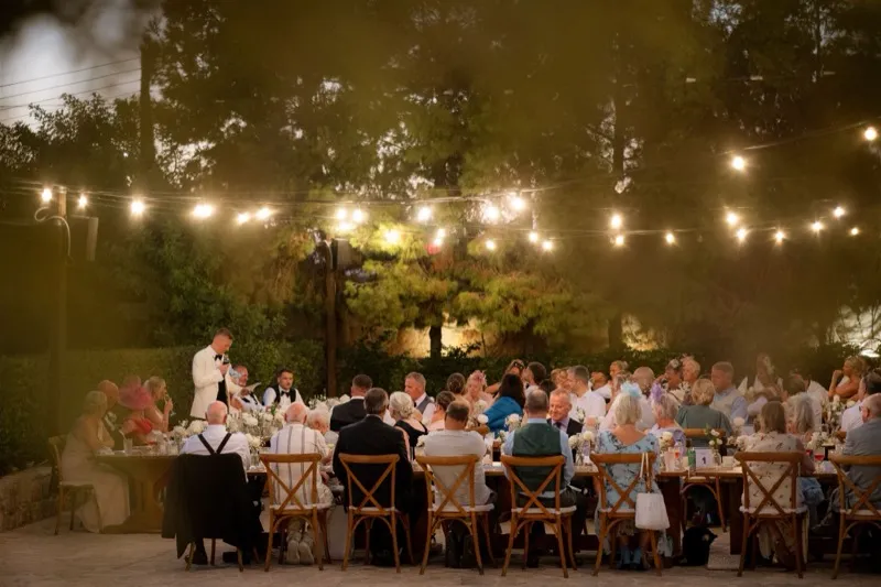 Documentary photograph of guests reacting during a Cyprus wedding speech