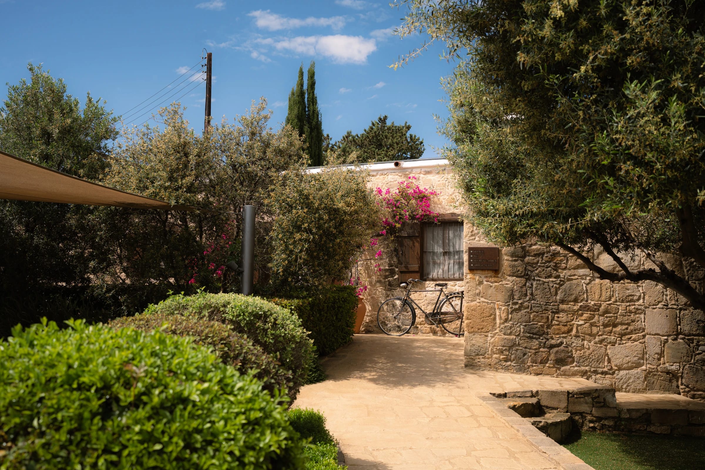 Stone cottage and bougainvillea on the Liopetro wedding venue grounds in Kouklia, Paphos.