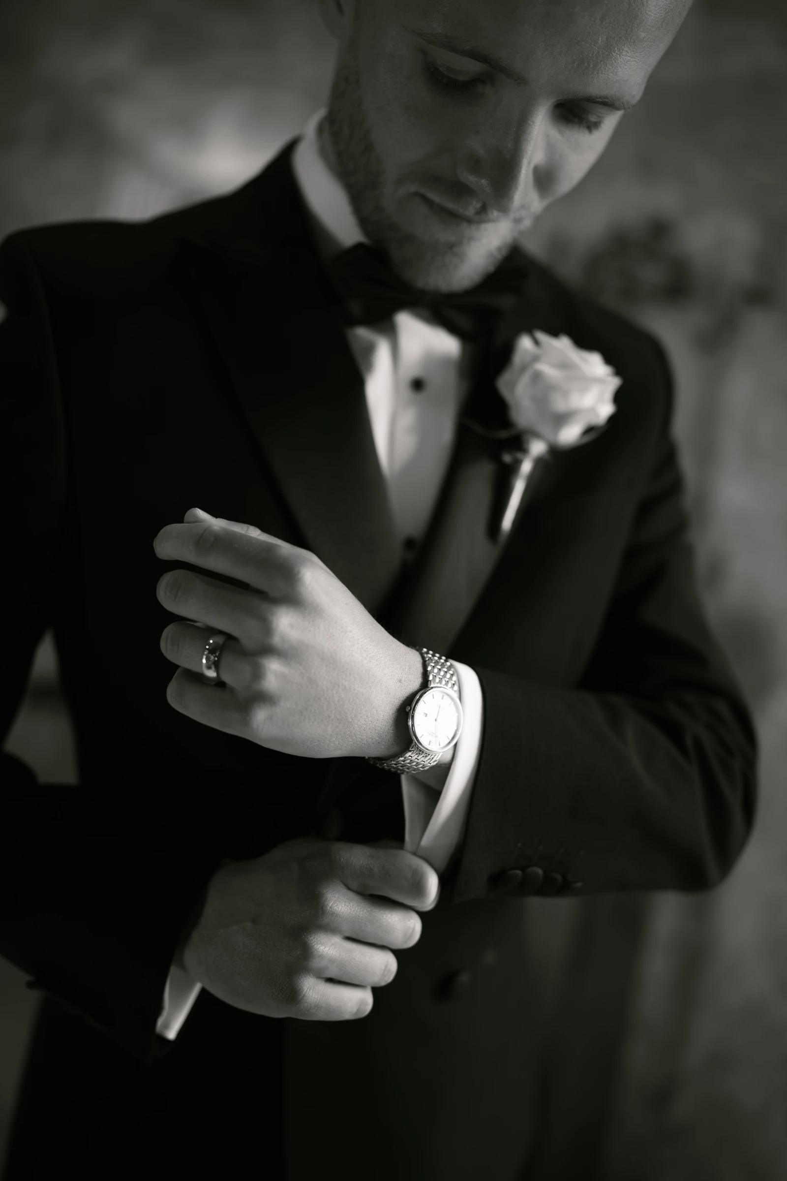 Black and white detail of the groom fastening his watch at Liopetro, Paphos.