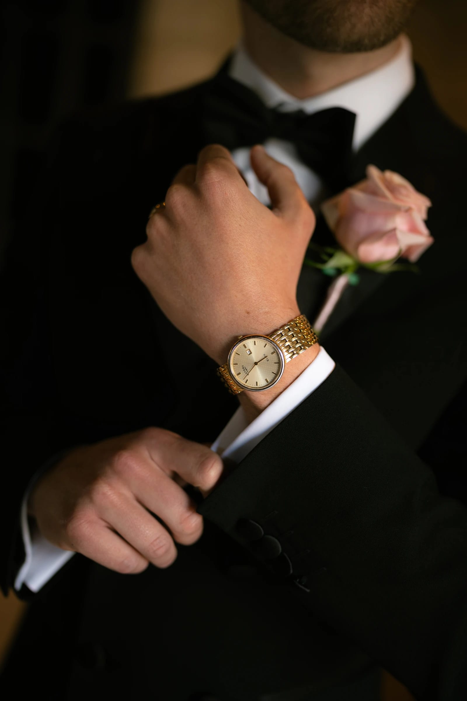 Groom Daniel with pink rose boutonnière and watch detail at Liopetro, Paphos.