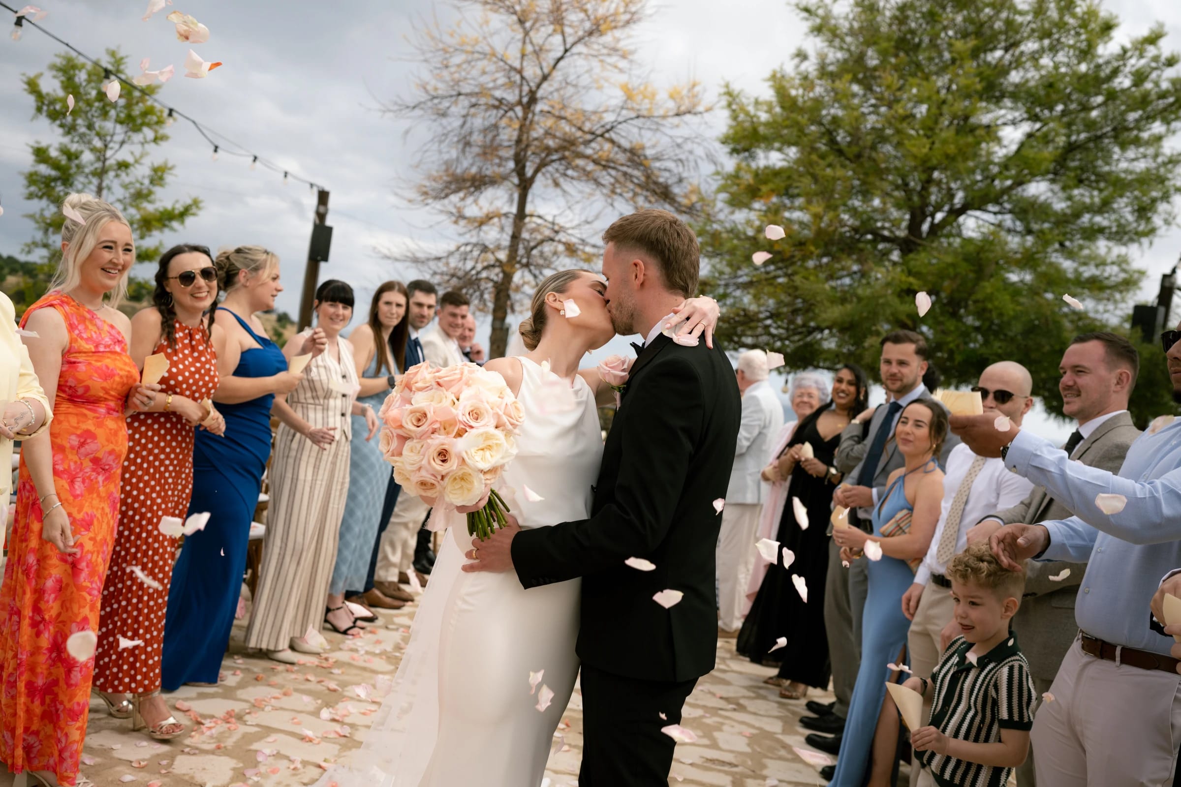 Confetti kiss as Daniel and Bailey exit the ceremony at Liopetro wedding venue, Kouklia, Paphos.