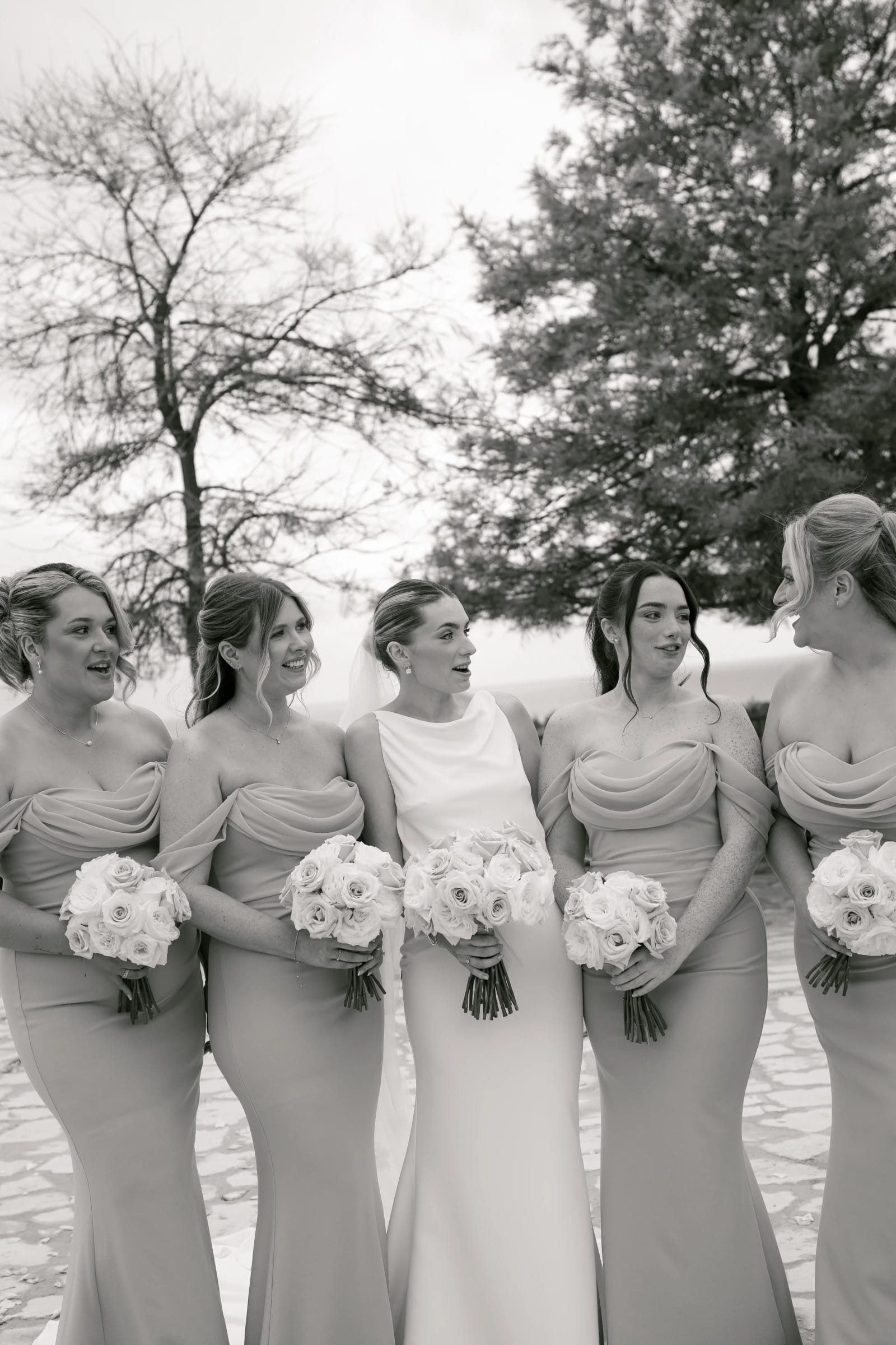 Black and white portrait of Bailey and her bridesmaids with bouquets at Liopetro, Paphos.