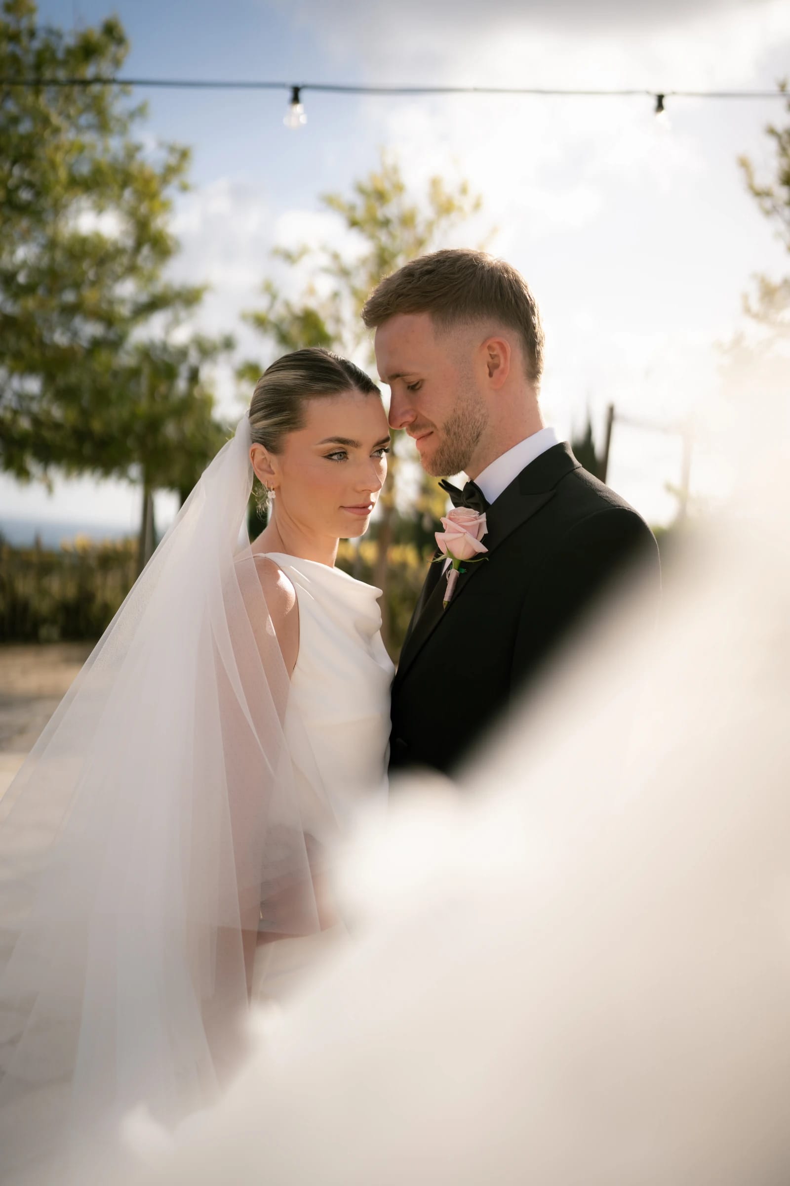 Daniel and Bailey forehead to forehead during their sunset portraits at Liopetro, Kouklia, Paphos.