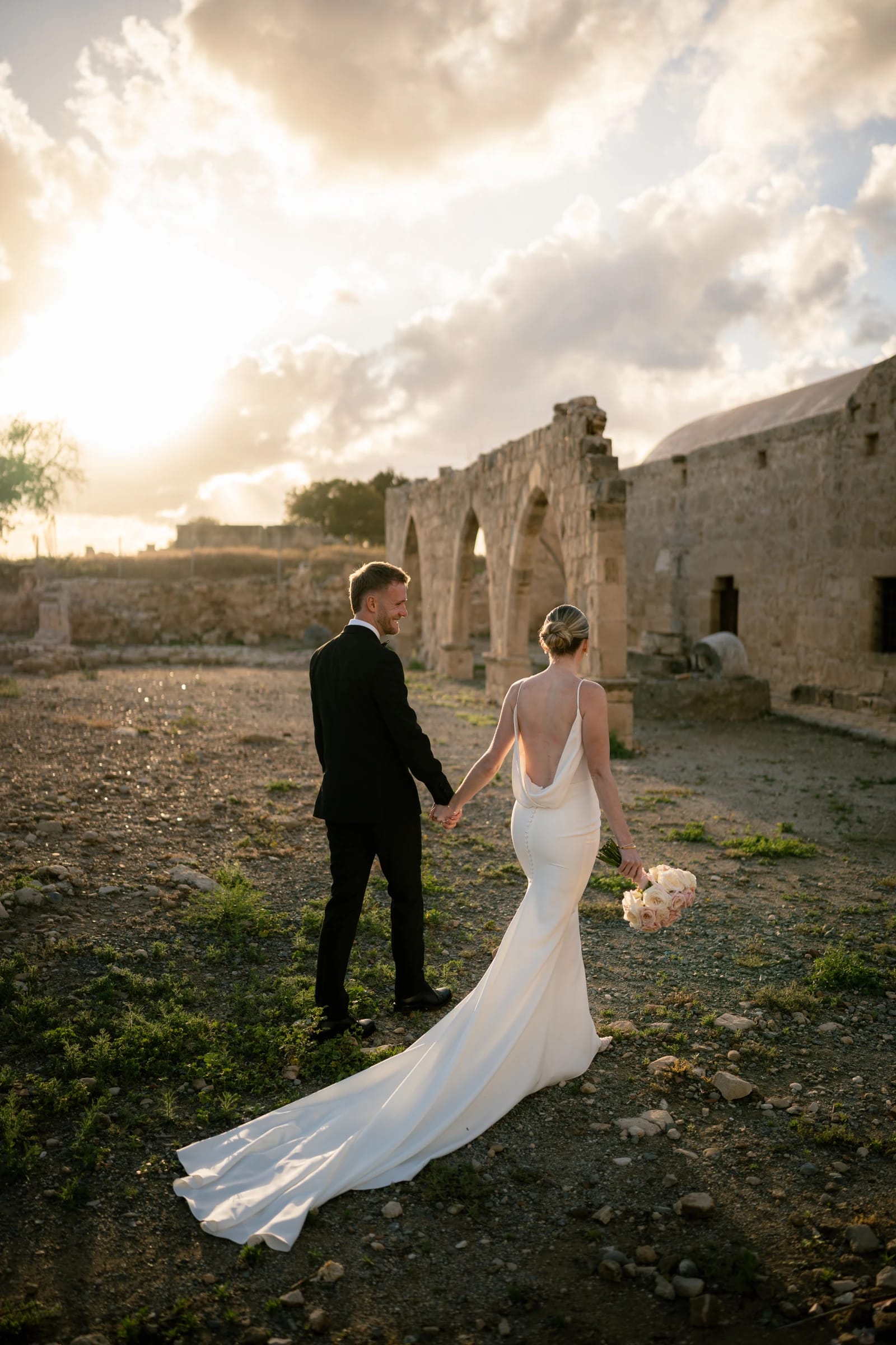 Daniel and Bailey walking through the stone ruins beside Liopetro at sunset, Kouklia, Paphos.