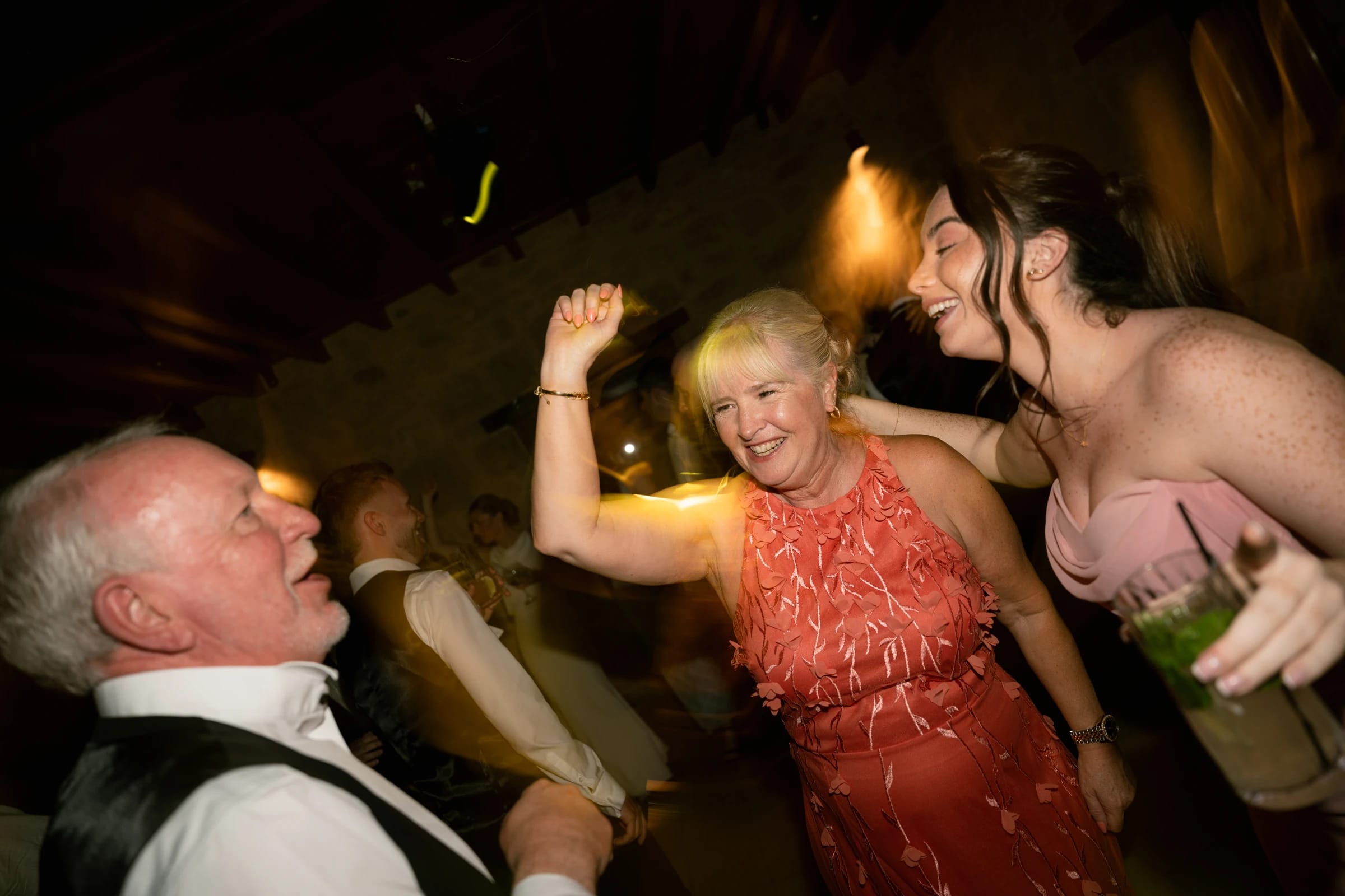 Parents and bridesmaid laughing and dancing late in the night at Liopetro, Paphos, Cyprus.