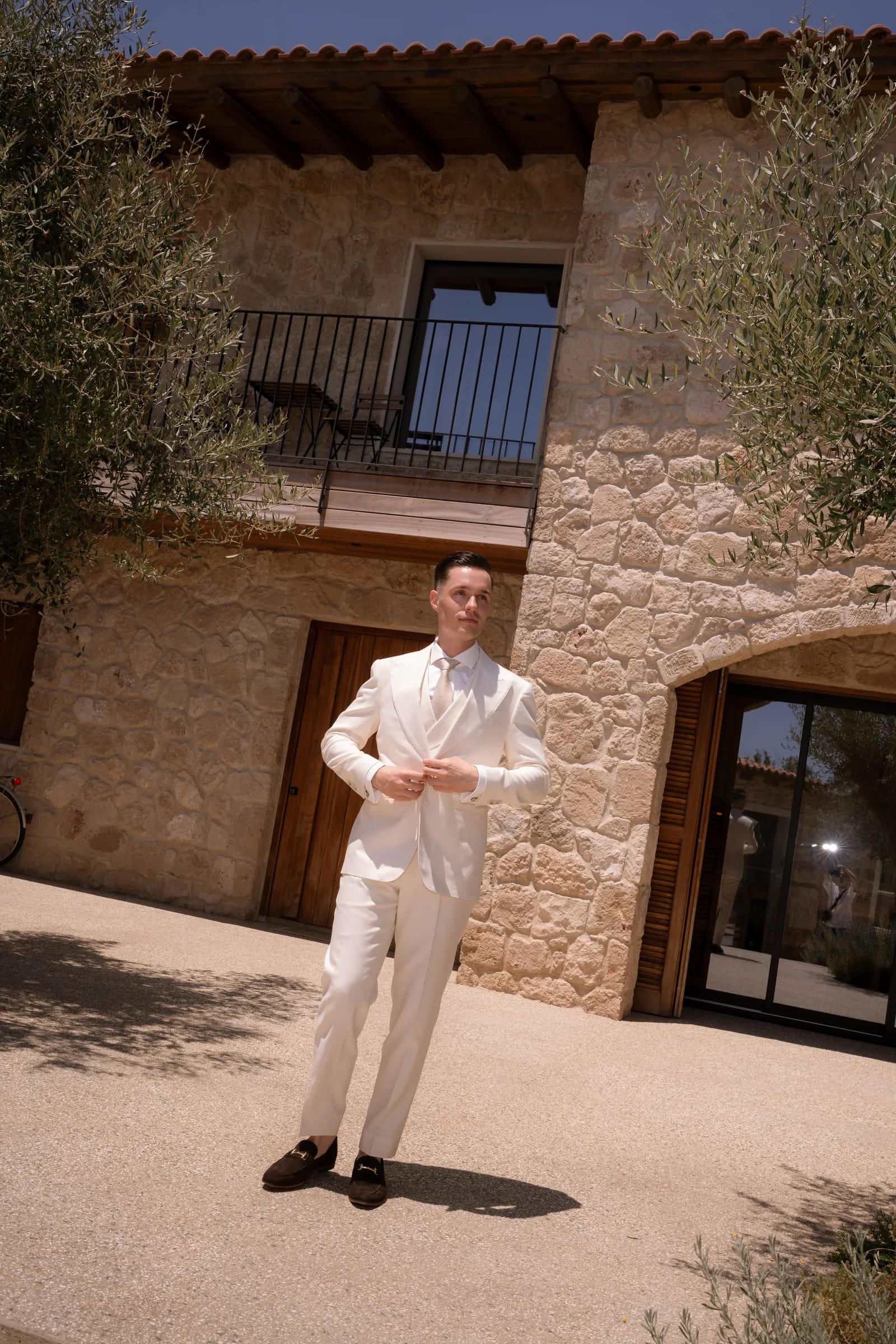 Frank in his cream three-piece suit in front of the stone villa at Liopetro, Kouklia, Paphos.