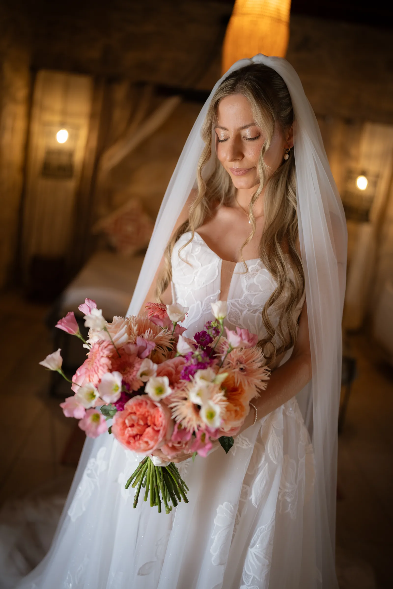 Franziska in her strapless floral-lace gown holding a coral and peach bouquet during preparations at Liopetro, Paphos.