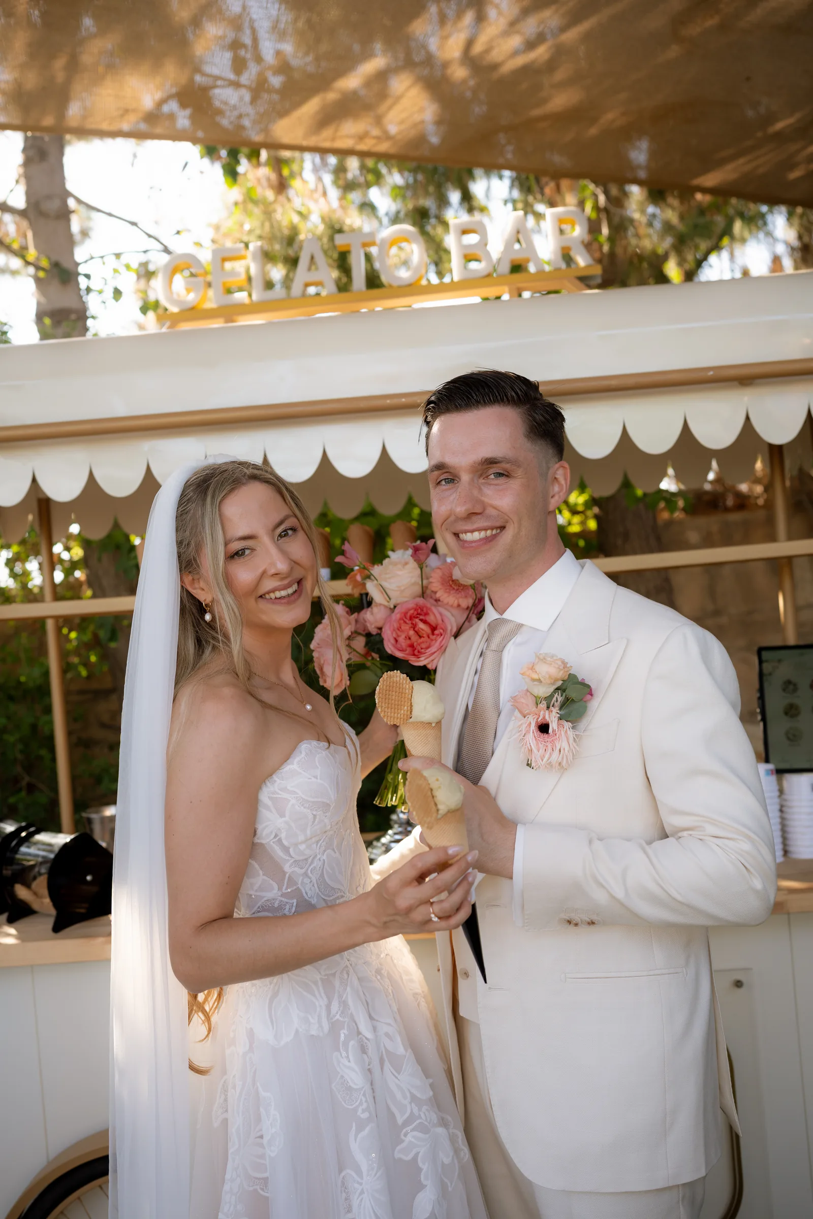 Frank and Franziska sharing an ice cream in front of the gelato bar at their Liopetro wedding reception, Paphos.