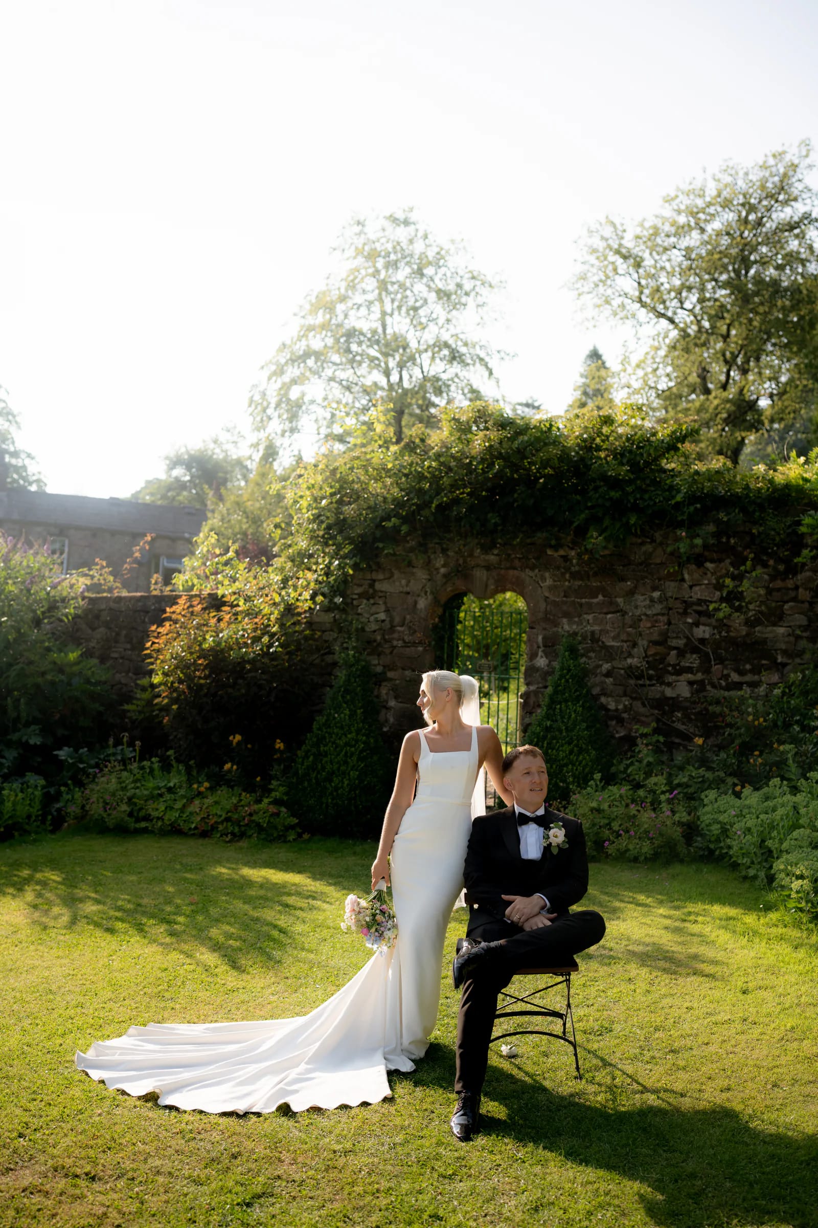 Ellie standing beside Josh for a relaxed portrait in the walled garden at Browsholme Hall