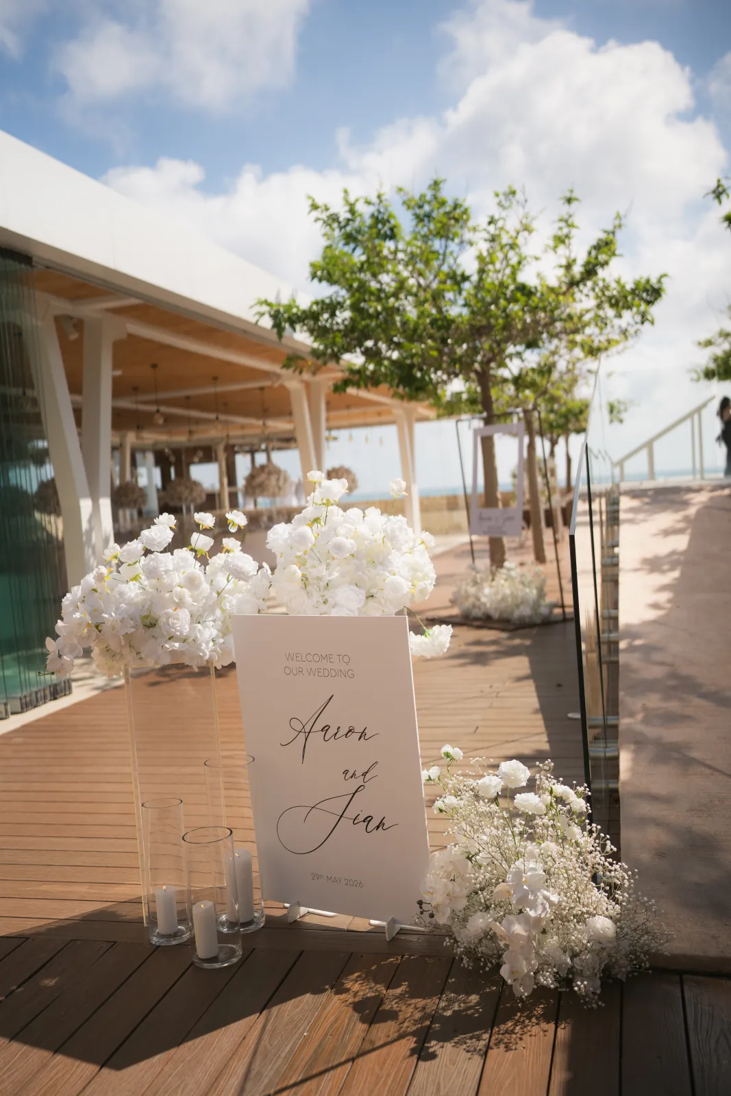 The 'Sian and Aaron' welcome sign and white florals on the clubhouse deck at Coral Residences, Paphos, Cyprus.