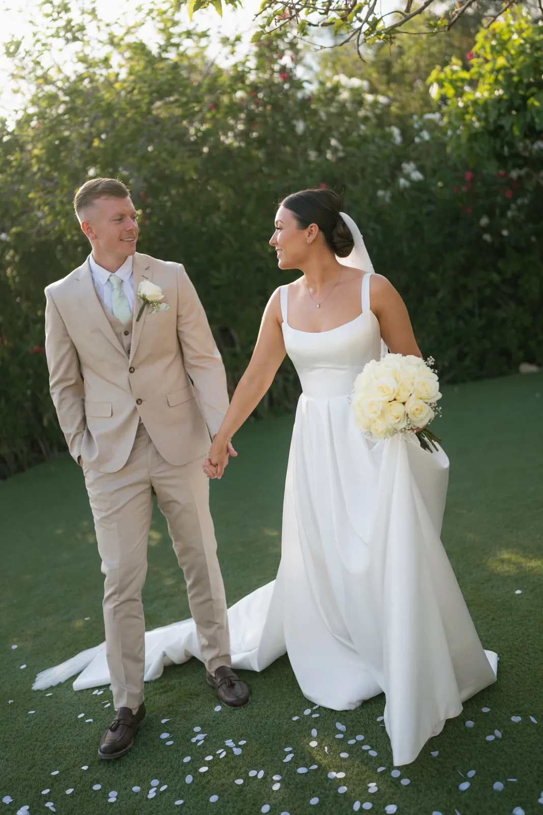 Sian and Aaron facing each other in the gardens at Coral Residences, Paphos, Cyprus.