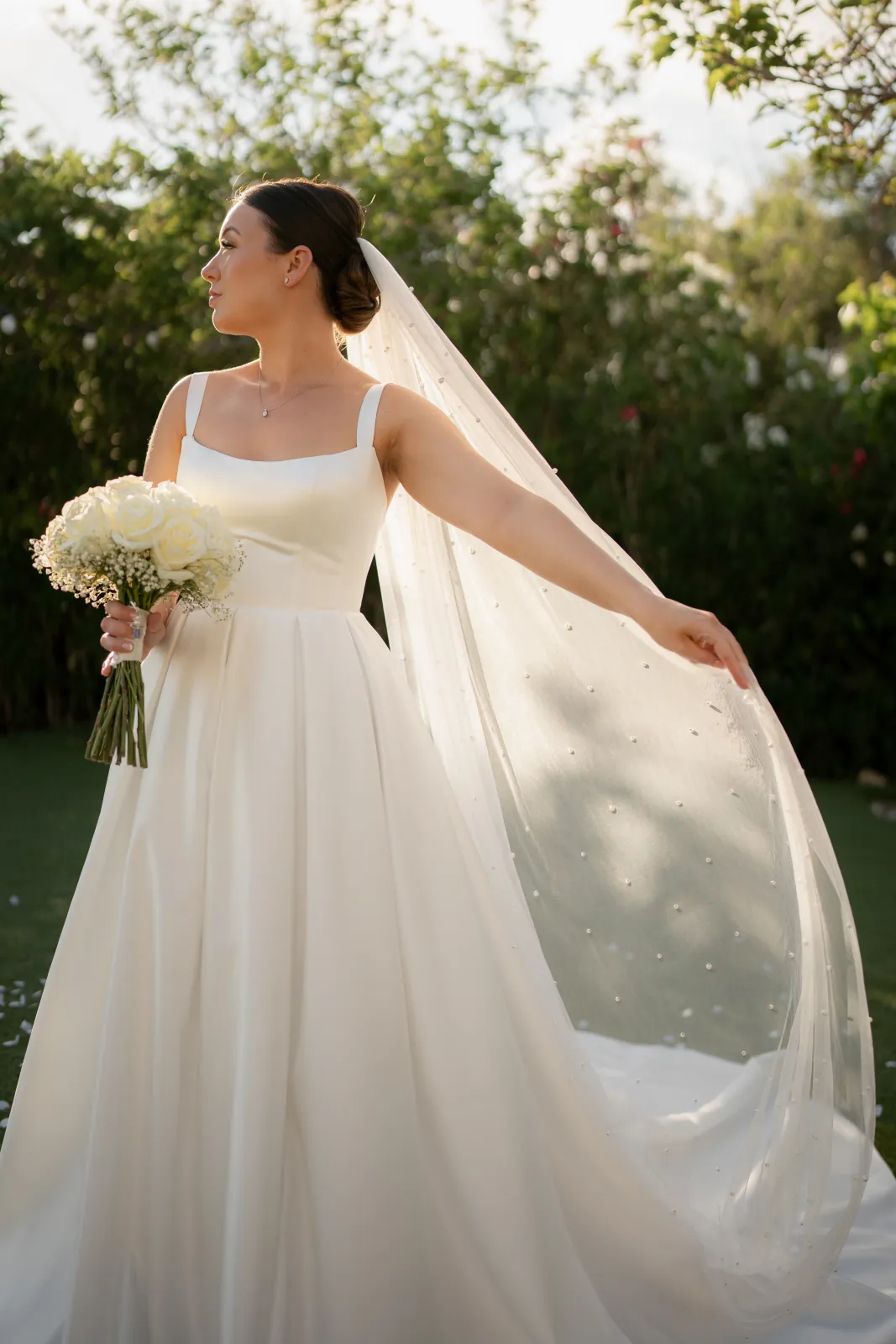 Sian in the garden with her long veil sweeping in the evening light at Coral Residences, Paphos.